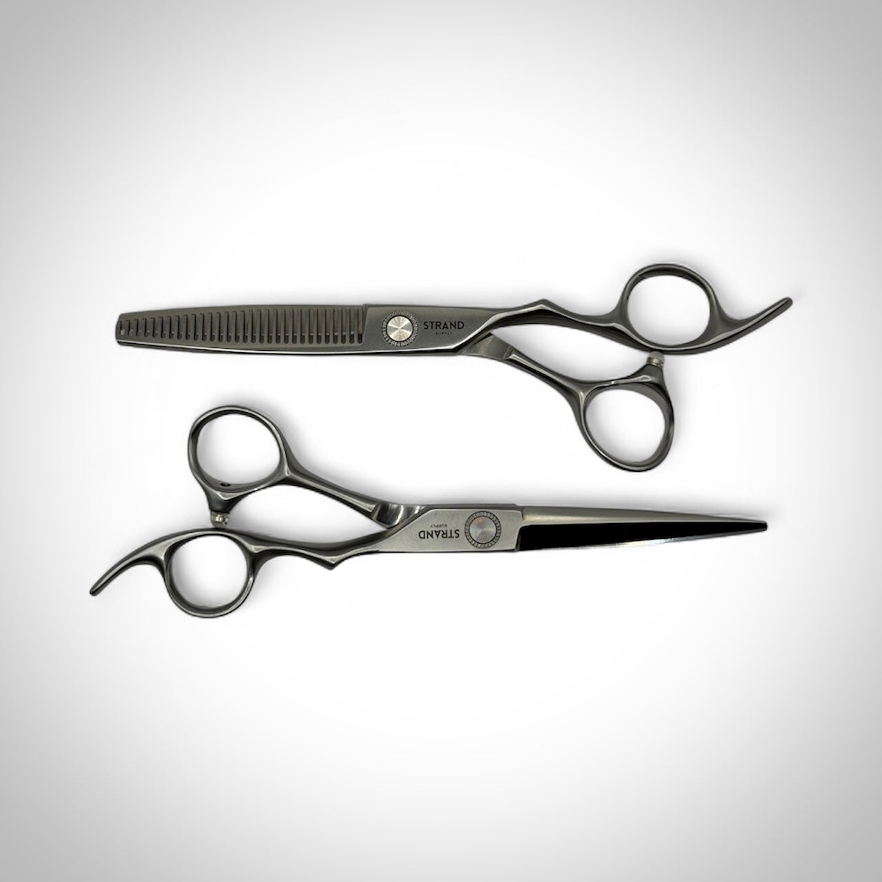 Two pairs of scissors on a white background